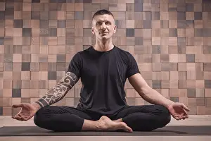 Adult man performs asana exercises