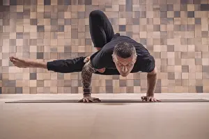 Adult man performs asana exercises
