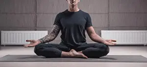 Adult man performs asana exercises