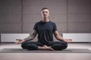 Adult man performs asana exercises