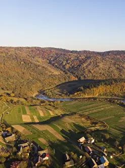 Aerial Drone View of autumn mountains with forests and river