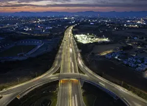 Aerial drone top view of a modern motorway junction roundabout with cars moving fast