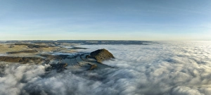 Aerial panorama of the wintry and fog-covered Hegaulandschaft shortly after sunrise