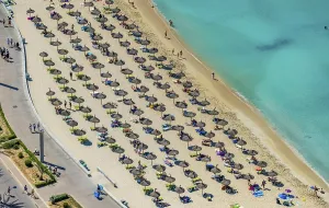 Aerial view, beach life and sunbathing with straw parasols at Playa de Palma