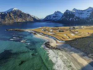 Aerial view of beach in front of steep mountains