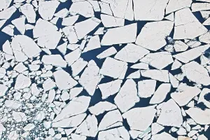 Aerial view of a blue lake on the Vatnajoekull glacier with ice floes