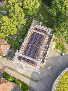 Aerial view of a building with a solar system on the roof
