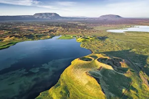 Aerial view of coast with green pseudo-craters