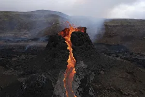 Aerial view, erupting volcano, crater with erupting lava and lava flow