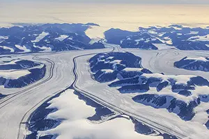 Aerial view of glaciers, glacier tongues and icy mountains on the coast