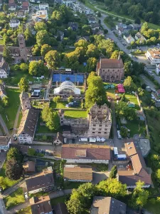 Aerial view of a green cityscape with historic buildings in summer