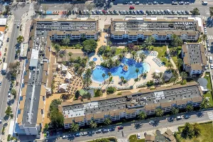 Aerial view, hotel complex with empty pool area and sun loungers