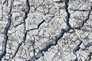 Aerial view, ice crevices and structures of volcanic ash and black lava in the ice and snow of the Vatnajoekull glacier
