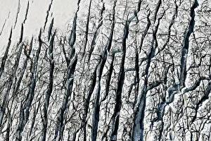 Aerial view, ice crevices and structures of volcanic ash and black lava in the ice and snow of the Vatnajoekull glacier