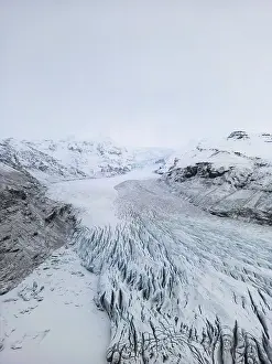 Aerial view of Iceland's winter landscape showcasing vast glaciers and rugged terrain