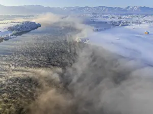 Aerial view of a lake in front of mountains