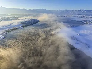 Aerial view of a lake in front of mountains