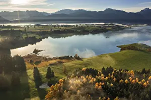 Aerial view of a lake in front of mountains in the morning light