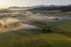 Aerial view of a lake in front of mountains in summer