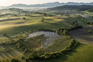 Aerial view of a lake in front of mountains in summer