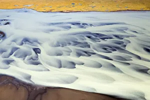 Aerial view of milky glacial water flow structures and patterns on the Holsa River near Selfoss