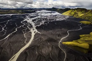 Aerial view, moss-covered mountains and the black sand of Maelifellssandur Desert