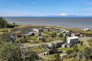 Aerial view of Ninilchik a small Alaskan Native village with Cook Inlet and Aleutian volcanoes in th