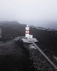 Aerial view, red and white lighthouse Garður Old Lighthouse