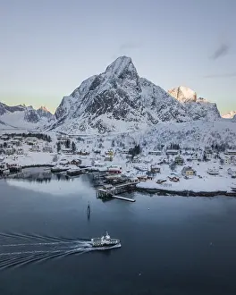 Aerial view of Reine with snow-covered mountains in winter