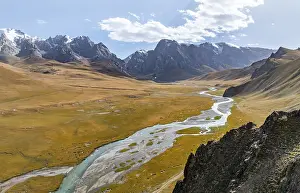 Aerial view, River Kol Suu winds through a mountain valley with hills covered with yellow grass