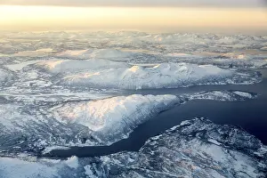 Aerial view, snow-covered mountains with fjord