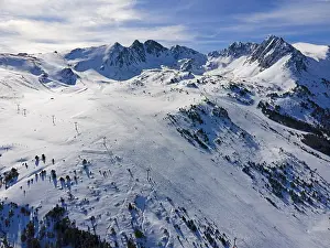 Category Mountain Landscapes Prints: Aerial view of a snow-covered ski resort with mountains in the background