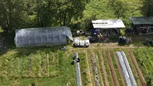 Aerial View of a Sustainable Farm with a Greenhouse Barn Structure