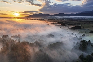 Category Mountain Landscapes Prints: Aerial view of trees and moorland in front of mountains in morning light