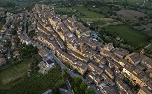 Aerial view of Treia, Italy, highlighting its remarkable medieval architecture nestled amid lush fields