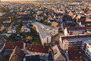Aerial view of a village with many residential buildings and a community building