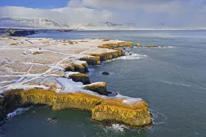 Aerial view over volcanic basalt cliff near Arnarstapi on the southern side of the Snaefellsnes Peninsula in winter