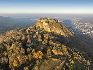 Aerial view of the volcanic cone Hohentwiel with the castle ruins illuminated by the evening sun