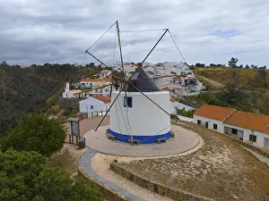 Aerial view of a windmill in the middle of a village