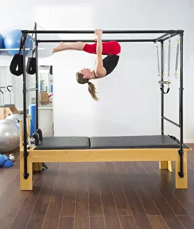 Aerobics pilates instructor woman in cadillac fitness exercise