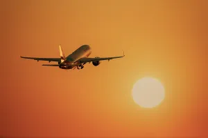 An aeroplane flies towards a large