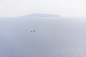 Aeroplane on landing approach, view of the island of Anafi