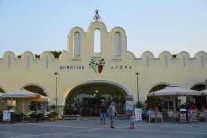 Agora, Municipal market hall, Lively market with white buildings and parasols in the foreground