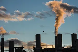 Air pollution from smokestacks of a factory in the sunset