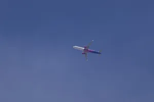 Airbus A321 jet aircraft of Wizz Air airlines in flight in a blue sky