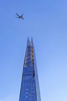 Airplane of British Airways flying over The Shard