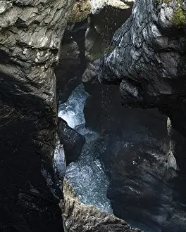 Alpine gorge with turquoise water and mossy cliffs in Lauterbrunnen Valley