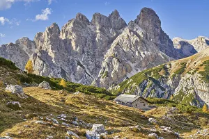 Alpine hut with mountain panorama in autumn