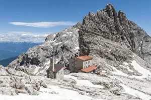 Alpine refuge Rifugio Pedrotti and chapel with rock Croz del Rifugio (2568 m)