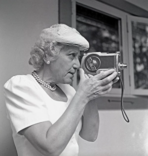 Amateur filming in the 1940s. An elderly woman uses a film camera